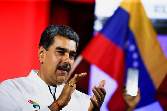  Venezuela's President Nicolas Maduro applauds on the day he addresses supporters during an electoral referendum over Venezuela's rights to the potentially oil-rich region of Esequiba, which has long been the subject of a border dispute between Venezuela and Guyana, in Caracas, Venezuela, December 3 (photo credit: REUTERS/LEONARDO FERNANDEZ VILORIA)