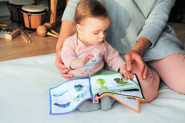 Mother reading to a baby girl. (photo credit: PICKPIK)