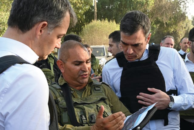  SPANISH PRIME Minister Pedro Sanchez (left) and his Belgian counterpart, Alexander de Croo, visit Kibbutz Be’eri, last month.  (photo credit: MONCLOA PALACE/REUTERS)