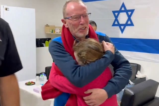  Emily Hand meets her father, Thomas Hand, after being released on November 25. (photo credit: IDF/Reuters)