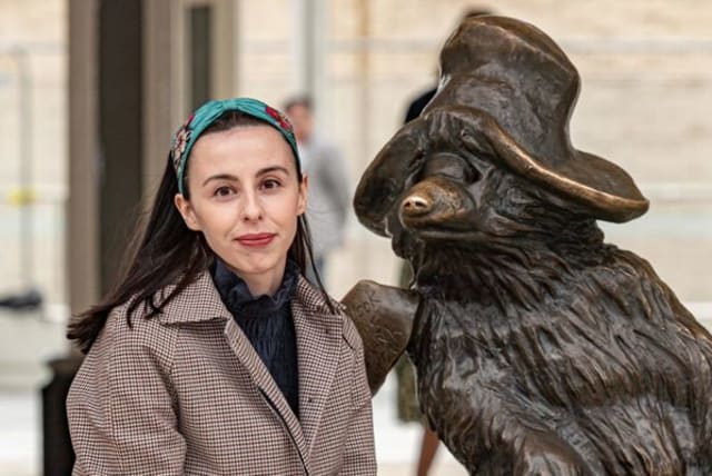  Dr. Amy Williams beside Paddington Bear at London’s Liverpool Station. The fabled character was inspired by the arrivals of many children in the late 1930s. (photo credit: ANDREW KING)