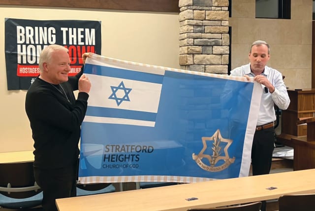  HAMMER presents an Israeli flag to Pastor Ray Phillips (Stratford) (photo credit: Jeremiah Morgan)