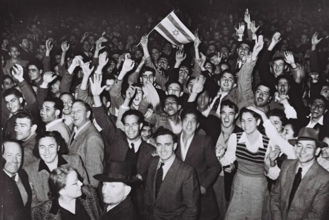  JUBILANT RESIDENTS of Tel Aviv celebrate with what would become the Israeli flag after the UN decision to approve the partition of Palestine, November 29, 1947. (photo credit: Hans Pins/GPO via Getty Images)