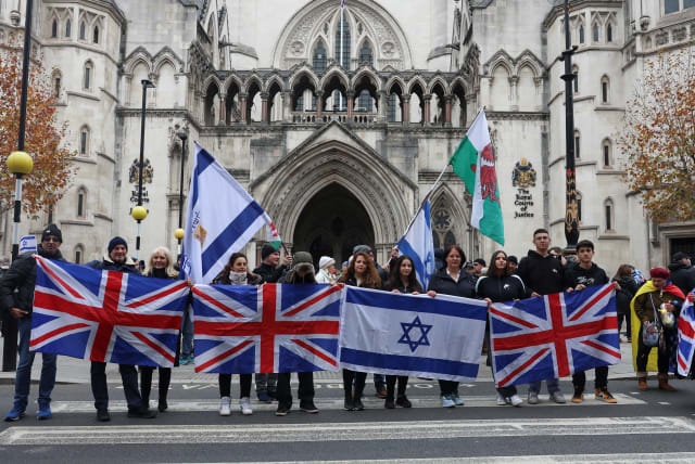  Demonstrators hold Israeli and British flags outside the Law Courts, during a march against antisemitism, after an increase in the UK, during a temporary truce between the Palestinian Islamist group Hamas and Israel, in London, Britain November 26, 2023. (photo credit: REUTERS/Susannah Ireland)