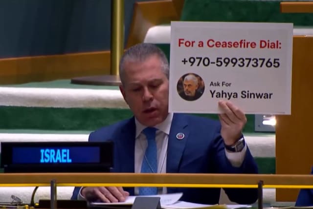 Israel's Ambassador to the UN Gilad Erdan held up a sign depicting Yahya Sinwar's office phone number at the UN. (photo credit: YOCHI COHEN)