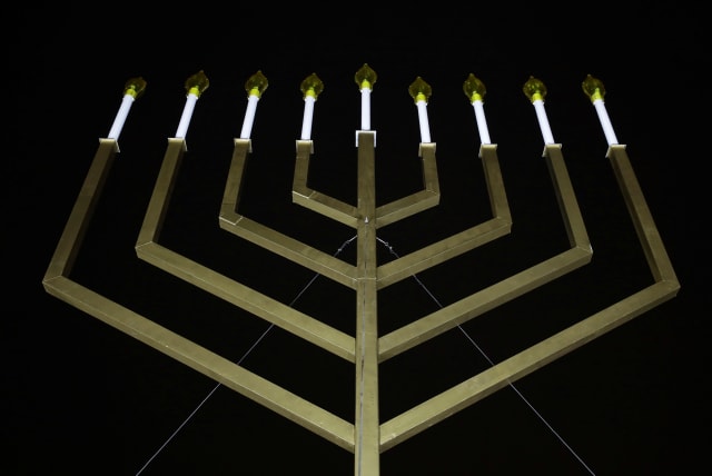  The National Menorah is illuminated after a lighting ceremony in Washington. (photo credit: REUTERS)