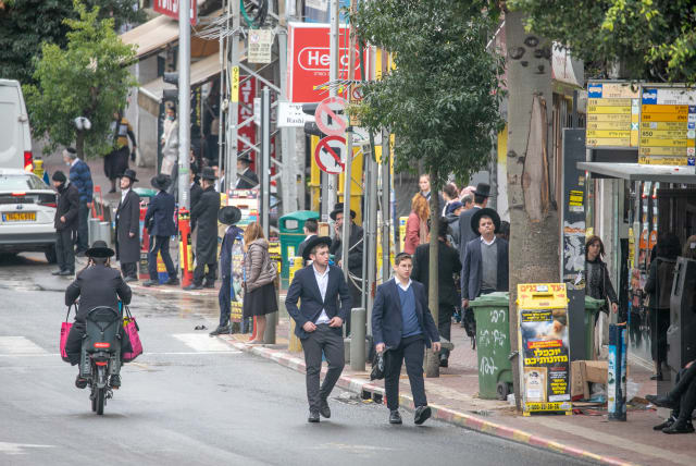  Ultra Orthodox Jews walk in the Ultra orthodox town of Bnei Brak on December 29, 2021. (photo credit: YOSSI ALONI/FLASH90)