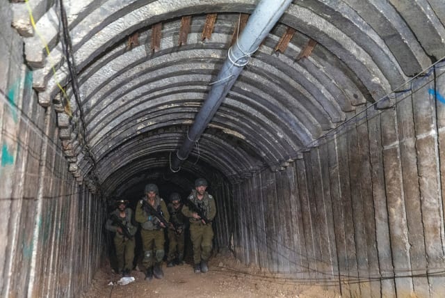  ISRAELI SOLDIERS walk, last week, through what the IDF said was an iron-girded tunnel designed by Hamas to disgorge carloads of Palestinian fighters for a surprise storming of the border, in the northern Gaza Strip (photo credit: AMIR COHEN/REUTERS)