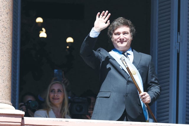  ARGENTINA’S PRESIDENT Javier Milei waves to supporters, as his sister Karina Milei looks on, after his swearing-in ceremony in Buenos Aires, earlier this month. (photo credit: AGUSTIN MARCARIAN/REUTERS)