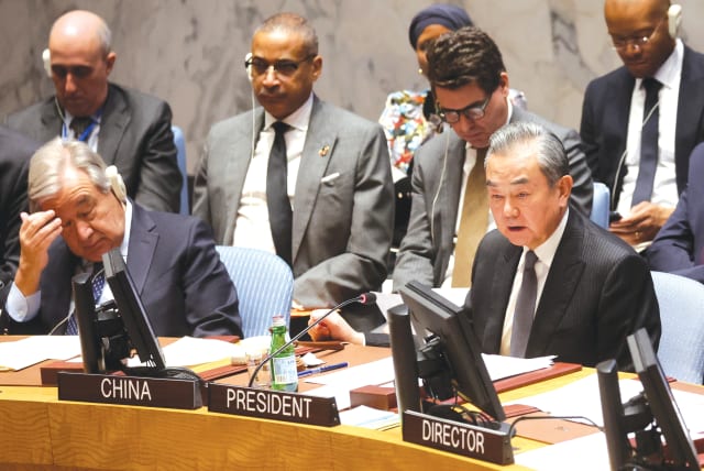  CHINA'S FOREIGN Minister Wang Yi and United Nations Secretary-General Antonio Guterres attend a UN Security Council meeting on the Israel-Hamas war, in late November. (photo credit: BRENDAN MCDERMID/REUTERS)