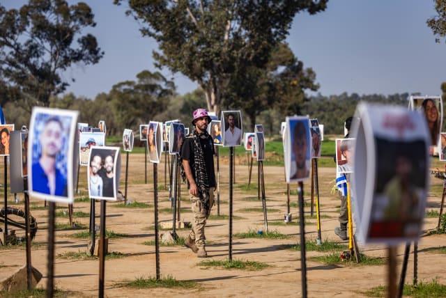 People visit the site of the Nova music festival massacre, in Re'im, near the Israeli-Gaza border, December 31, 2023 (photo credit: YONATAN SINDEL/FLASH90)