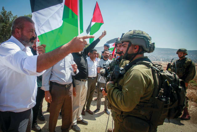  IDF SOLDIERS stand guard while Palestinians and left-wing activists protest near the Jewish settlement of Elon Moreh, east of Nablus, in 2022 (photo credit: NASSER ISHTAYEH/FLASH90)