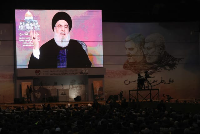  Lebanon's Hezbollah leader Sayyed Hassan Nasrallah addresses his supporters through a screen during a ceremony to mark the fourth anniversary of the killing of senior Iranian military commander General Qassem Soleimani in a U.S. attack, in Beirut's southern suburbs, Lebanon January 3, 2024 (photo credit: REUTERS/MOHAMED AZAKIR)