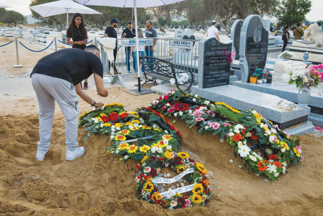  THE GRAVES of Israelis Shay Silas Nigreke and his son Aviad Nir, who were murdered by terrorists in Huwara last August.  (photo credit: FLASH90)