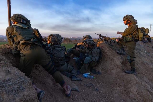  Israeli soldiers take position near the border fence with the Gaza Strip, southern Israel, on January 7, 2024. (photo credit: CHAIM GOLDBEG/FLASH90)