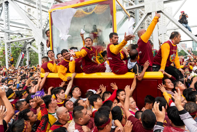  Filipino devotees join the annual Catholic procession of the Black Nazarene during its feast day in Manila, Philippines, January 9, 2024 (photo credit: REUTERS/LISA MARIE DAVID)