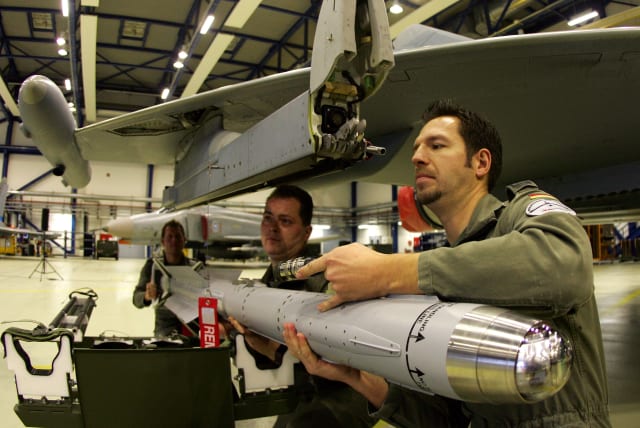 Technical sergeants of the German Air Force attach a new air-to-air missile IRIS-T on a Eurofighter aircraft (photo credit: REUTERS/FABRIZIO BENSCH)