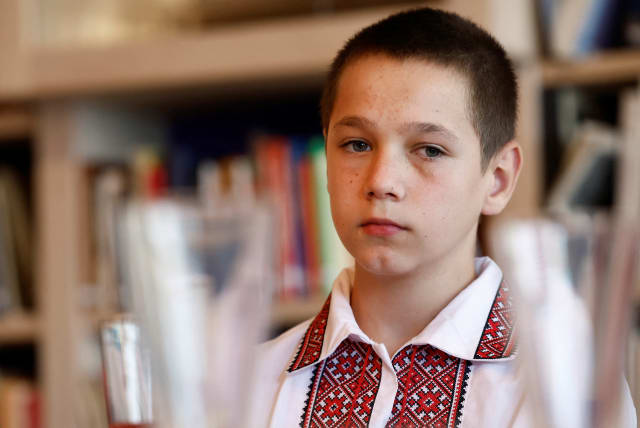  Ukrainian boy Sashko, 11, who was brought home after being taken to Russian controlled territory, reacts during a meeting in the Children's Book Museum in The Hague, Netherlands September 14, 2023 (photo credit: REUTERS/PIROSCHKA VAN DE WOUW)