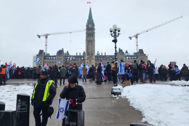  Demonstrators holding Israeli flags converge on Parliament Hill for a rally in Ottawa, Ontario, Canada December 4, 2023.  (photo credit: REUTERS/Ismail Shakil)