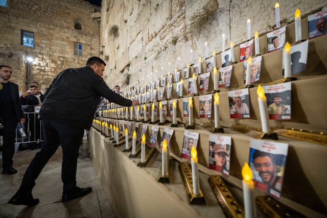 People light the Hanukkah candles for the release of Israelis kidnapped in the Gaza Strip by Hamas terrorists at the Western Wall, December 7, 2023. (photo credit: YONATAN SINDEL/FLASH90)