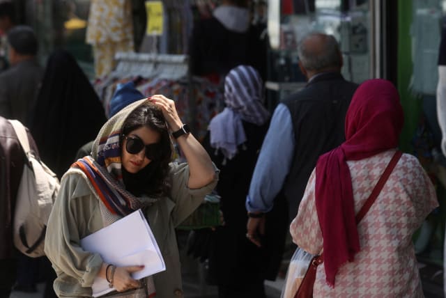  An Iranian woman walks on a street amid the implementation of the new hijab surveillance in Tehran, Iran, April 15, 2023 (photo credit: MAJID ASGARIPOUR/WANA/REUTERS)