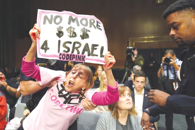  A PROTESTER is removed during a US Senate Appropriations Committee hearing on President Biden's supplemental funding request for Israel and Ukraine, in October. The Gaza war has implications for inter-power relations in various contexts such as the war in Ukraine, the writer notes. (photo credit: KEVIN LAMARQUE/REUTERS)