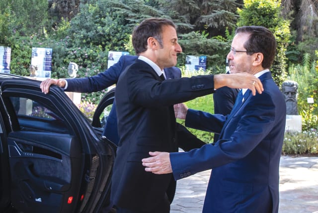  FRENCH PRESIDENT Emmanuel Macron embraces President Isaac Herzog, during his visit to Jerusalem in October, following the Hamas massacres. (photo credit: OREN BEN HAKOON/FLASH90)