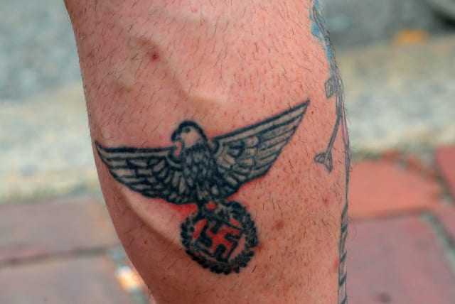  A man wearing a “Nationalist Social Club 131” (NSC 131) shirt shows his swastika tattoo during a pro-police rally, following weeks of protests against racial inequality in the aftermath of the death in Minneapolis police custody of George Floyd, in Boston, Massachusetts, U.S. June 27, 2020. (photo credit: BRIAN SNYDER/REUTERS)