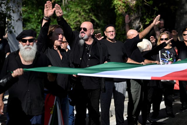 Neo-fascists do the Nazi salute as they gather in the town where dictator Benito Mussolini was born to commemorate the hundredth anniversary of the March on Rome, in Predappio, Italy, October 30, 2022.  (photo credit: REUTERS/Flavio Lo Scalzo/File Photo)