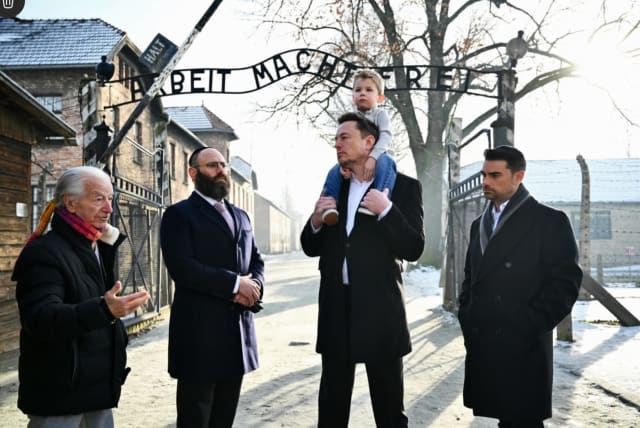 Businessman Elon Musk, third from right, and US political commentator Ben Shapiro, furthest right, visit the site of the Auschwitz-Birkenau death and concentration camp. (photo credit: YOAV DODKOVITZ)