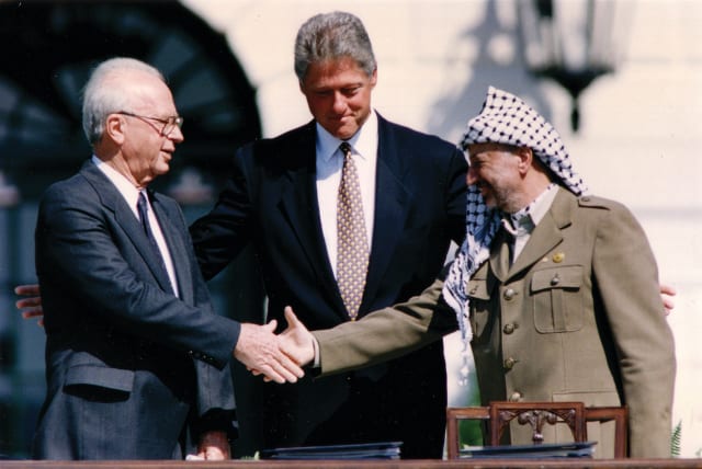  BILL CLINTON, Yitzhak Rabin, and Yasser Arafat, after the signing of the Israel-PLO Declaration of Principles at the White House in 1993: What’s troubling is the resignation that any renewed peace negotiation will be futile because everything that’s been tried before didn’t work, the writer laments (photo credit: GARY HERSHORN/REUTERS)