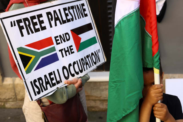  A boy holds a Palestinian flag during a demonstration to express support for the people of Palestine, in Cape Town, South Africa, October 9, 2023. (photo credit: REUTERS/ESA ALEXANDER)