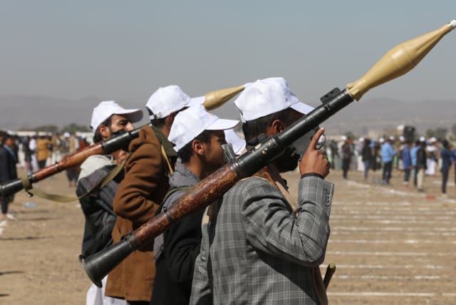  Armed Houthi followers hold RPG launchers as they take part in a parade during a protest to decry the U.S.-led strikes on Houthi targets and to show support to Palestinians in the Gaza Strip, amid the ongoing conflict between Israel and the Palestinian Islamist group Hamas, near Sanaa, Yemen Januar (photo credit: REUTERS/KHALED ABDULLAH)