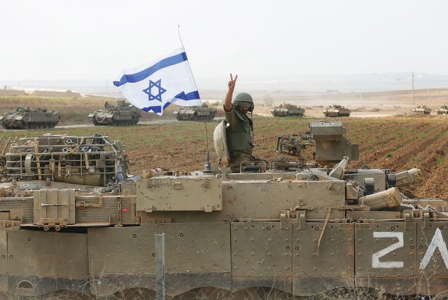 A SOLDIER poses atop a tank near the border with Gaza in October of last year.  (photo credit: Amir Levy/Getty Images)