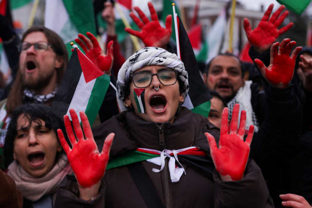 Pro-Palestinian protesters gather near the International Court of Justice (ICJ), on the day judges hear a request for emergency measures by South Africa to order Israel to stop its military actions in Gaza, in The Hague, Netherlands January 12, 2024. (photo credit: REUTERS/THILO SCHMUELGEN)