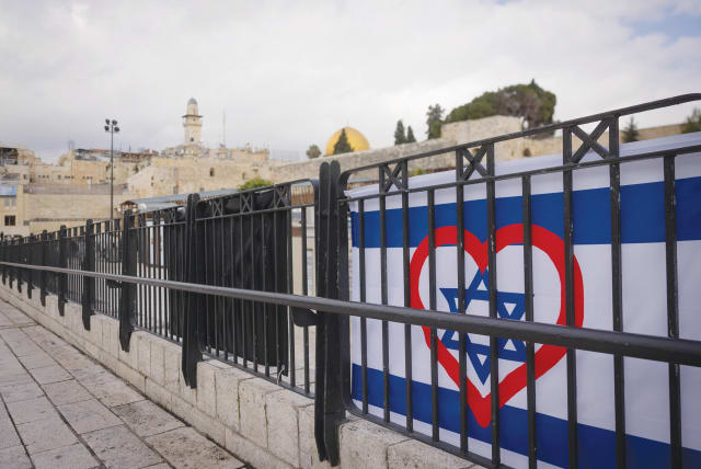  AN ISRAELI flag is enhanced with a heart in Jerusalem’s Old City. As we’ve seen firsthand over the past three and a half months, we are so much more powerful when, despite our differences, we are united under one banner, the writer affirms.  (photo credit: FLASH90/CHAIM GOLDBERG)
