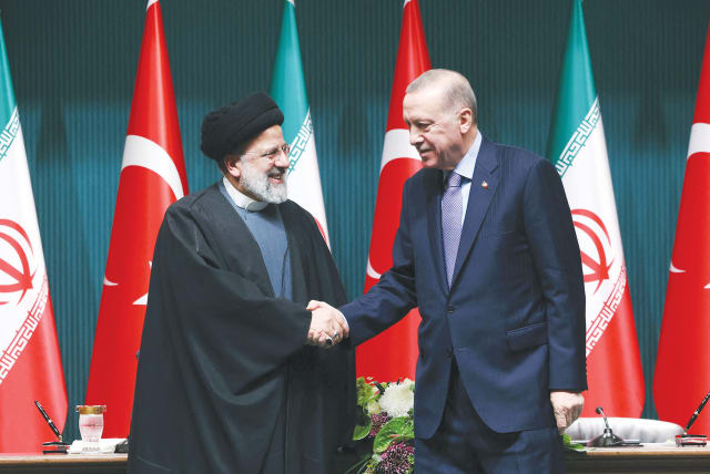  TURKEY’S PRESIDENT Recep Tayyip Erdogan and Iran’s President Ebrahim Raisi shake hands following a news conference in Ankara last week. It is not clear if Iran’s enablers Qatar and Turkey or its allies Russia and China actually call the shots in Tehran or have any influence, says the writer. (photo credit: Turkish Presidential Press Office/Reuters)