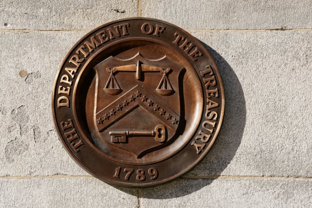   A bronze seal for the Department of the Treasury is shown at the U.S. Treasury building in Washington, US, January 20, 2023.  (photo credit: REUTERS/KEVIN LAMARQUE/FILE PHOTO)