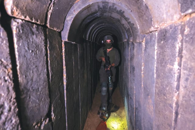  AN IDF soldier walks through a tunnel underneath Shifa Hospital in Gaza City, in November. (photo credit: RONEN ZVULUN/REUTERS)