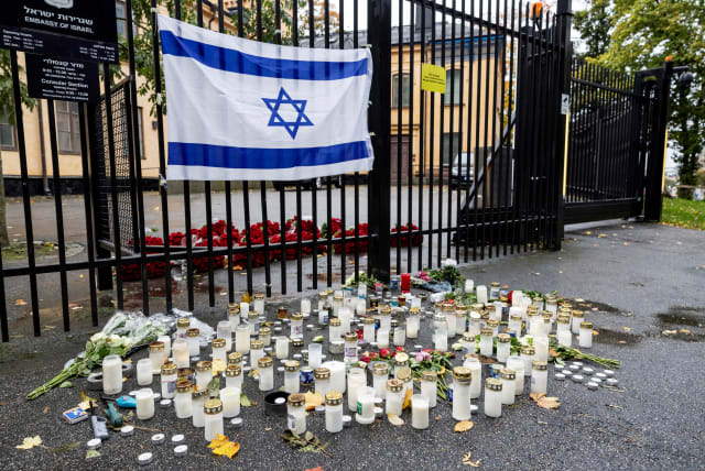  Flowers and candles are placed outside the Israeli embassy in Stockholm, Sweden, on October 11, 2023 (photo credit: VIA REUTERS)