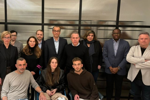  Released hostages Mia and Itai Regev with their father Itai (bottom) with a delegation of UN officials in Israel, including Gilad Erdan, after the Regev siblings spoke of their captivity in Gaza. (photo credit: Via Maariv)