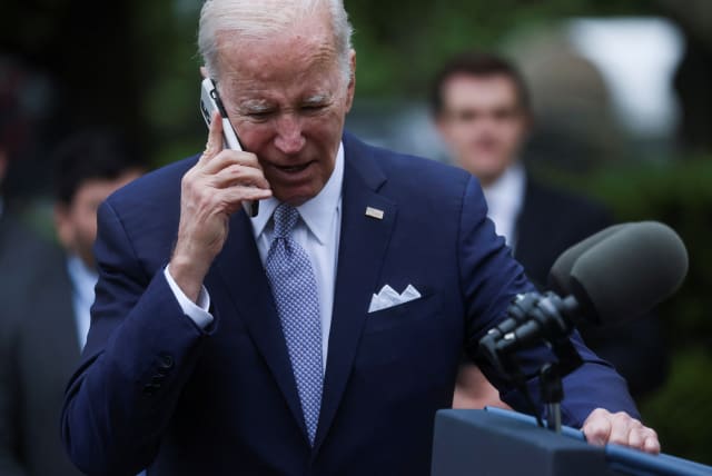  U.S. President Joe Biden speaks on a phone following an event marking National Small Business Week, in the Rose Garden of the White House in Washington, U.S., May 1, 2023. (photo credit: REUTERS/LEAH MILLIS)