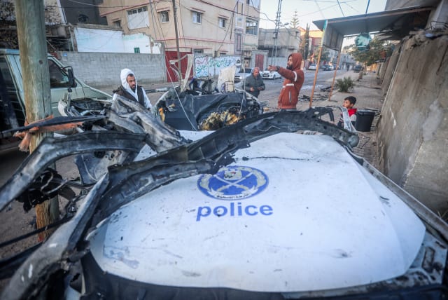  Palestinians at the site of a destroyed police car after it was hit from an Israeli airstrike in Rafah, on February 7, 2024 (photo credit: ATIA MOHAMMED/FLASH90)