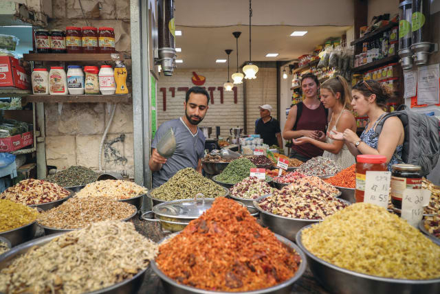  SHOPPING FOR ‘a few staples’ in Jerusalem’s Mahaneh Yehuda market. (photo credit: NATI SHOHAT/FLASH90)