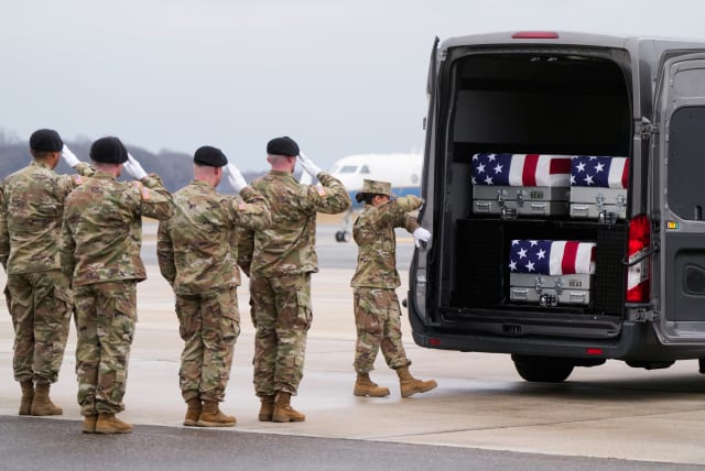  Members of the military salute during the dignified transfer of the remains of Army Reserve Sergeants William Rivers, Kennedy Sanders and Breonna Moffett, three U.S. service members who were killed in Jordan during a drone attack carried out by Iran-backed militants, February 2, 2024.  (photo credit: REUTERS/JOSHUA ROBERTS)