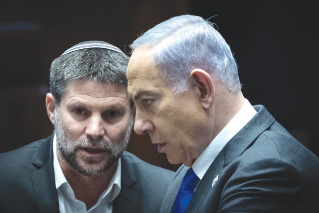 PRIME MINISTER Benjamin Netanyahu and Finance Minister Bezalel Smotrich confer in the Knesset, last week. Moody’s announcement on lowering Israel’s credit rating is viewed by both Netanyahu and Smotrich as politically motivated, the writer notes.  (photo credit: YONATAN SINDEL/FLASH90)