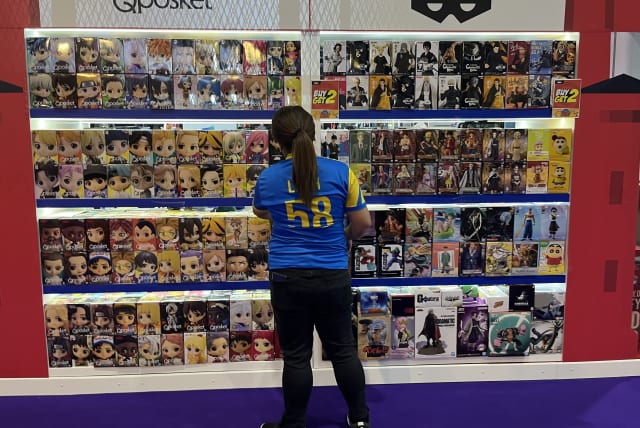 A salesperson at The Middle East Film & Comic Con in the United Arab Emirates.  (photo credit: Omnia Al Desoukie/The Media Line)