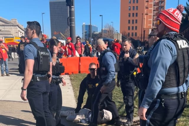 Police officers detain a person outside of Union Station following a shooting near an outdoor celebration of the NFL champion Chiefs' Super Bowl victory, in Kansas City, Missouri, U.S. February 14, 2024 in this screen grab obtained from social media video. (photo credit: Alyssa Contreras/via REUTERS)