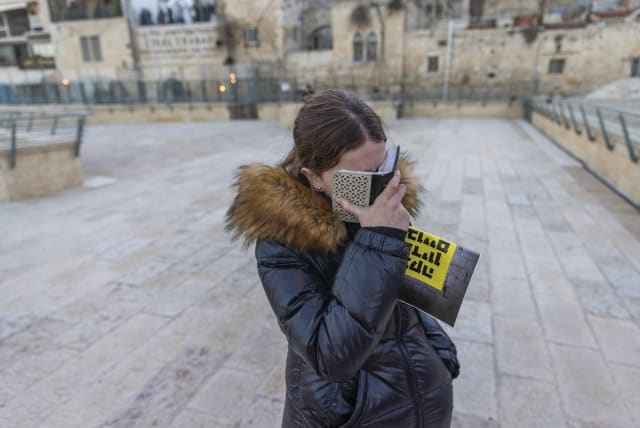  An illustrative photo of a woman praying. (photo credit: Chaim Goldberg/Flash90)