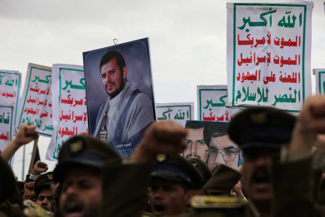  Demonstrators, predominantly Houthi supporters, hold a picture of the Houthi leader Abdul-Malik al-Houthi and signs as they rally to show support to the Palestinians in the Gaza Strip, amid the ongoing conflict between Israel and the Palestinian Islamist group Hamas, in Sanaa, Yemen February 16, 20 (photo credit: KHALED ABDULLAH/REUTERS)